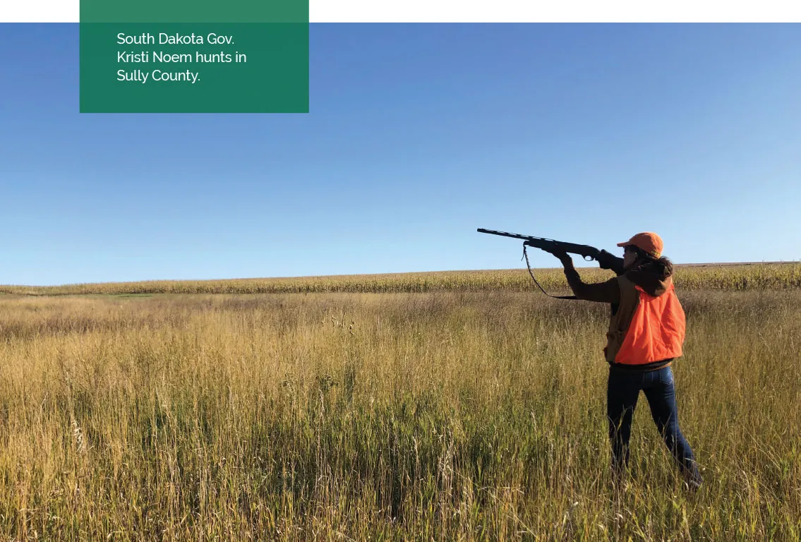 A hunter with a gun in his hands shooting