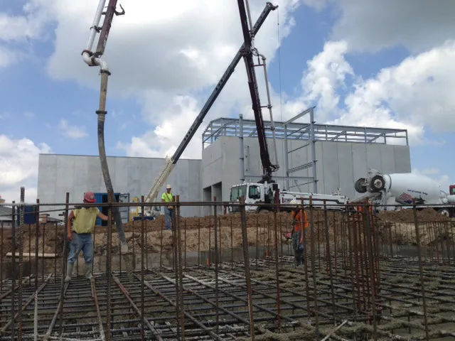 Biomass handling buildings in the background and equipment foundation rebar.
