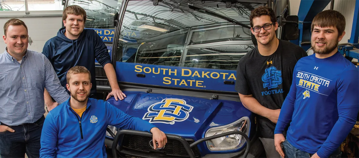 Colin LeBrun, Brady Buck, Mitchell Sandey, Caleb Lang and Alex Koepke work on the project in South Dakota State University’s Ag Engineering lab.