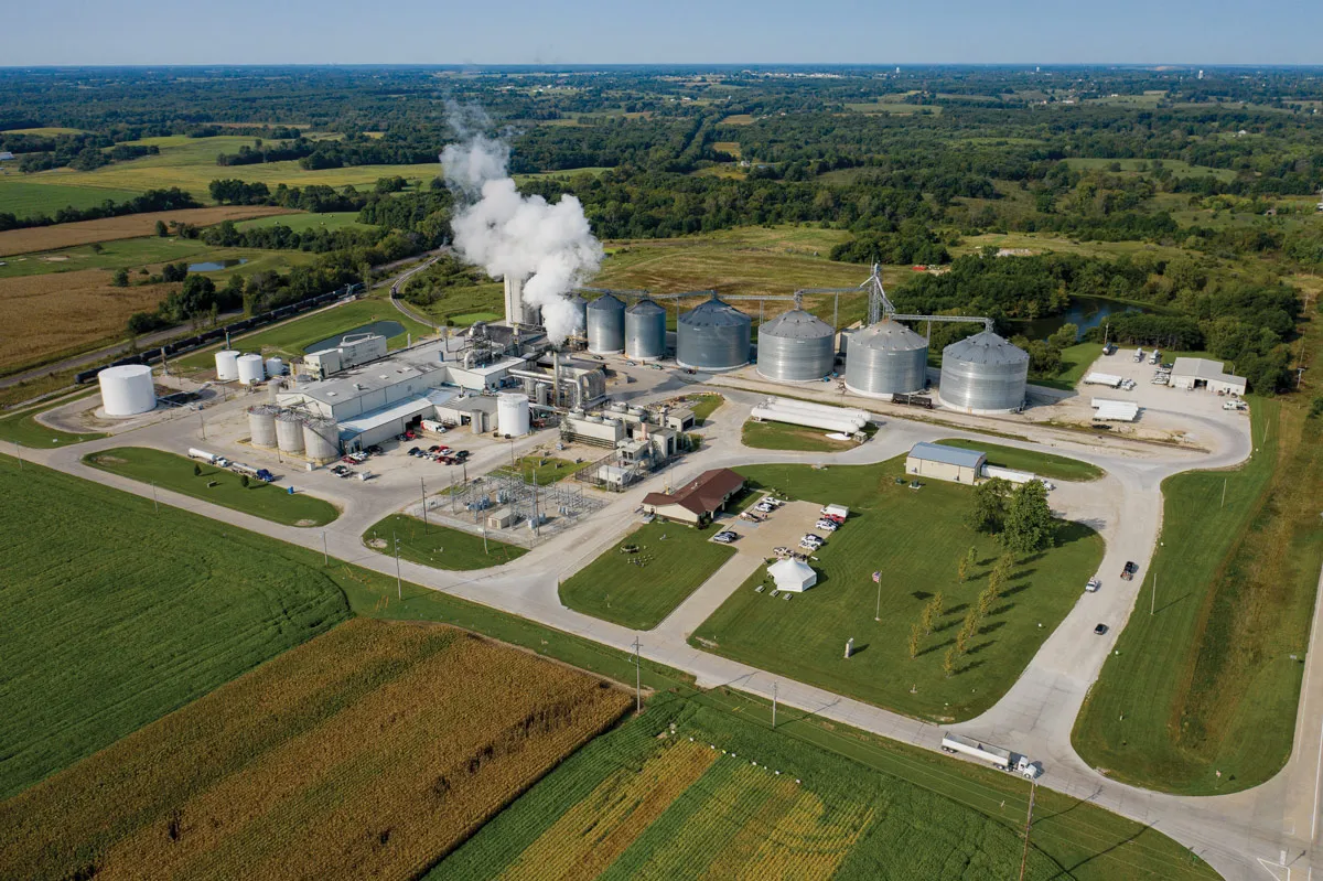 Industrial plant features silos and a smokestack