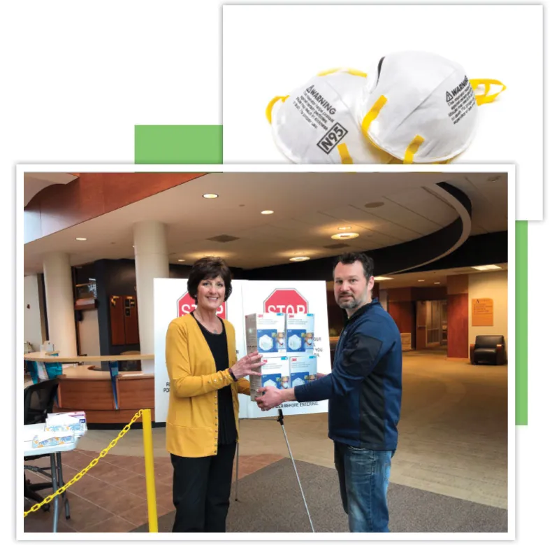 Two adults in a hospital-like lobby hold a safety poster together, with STOP signs behind
