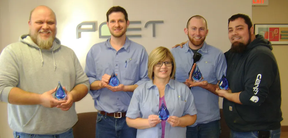 Five people holding an award
