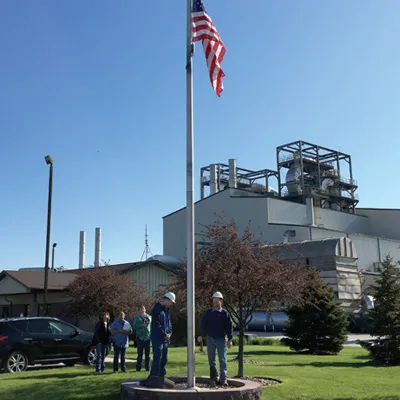 American flag on flagpole near workers