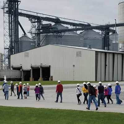Group of workers in hard hats walking at site