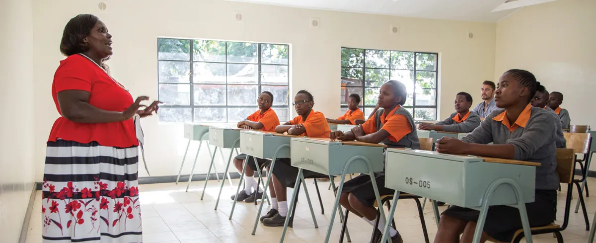 Biology professor Mary Mwo teaches some of the girls at Travellers’ Oasis Centre in the renovated classroom.
