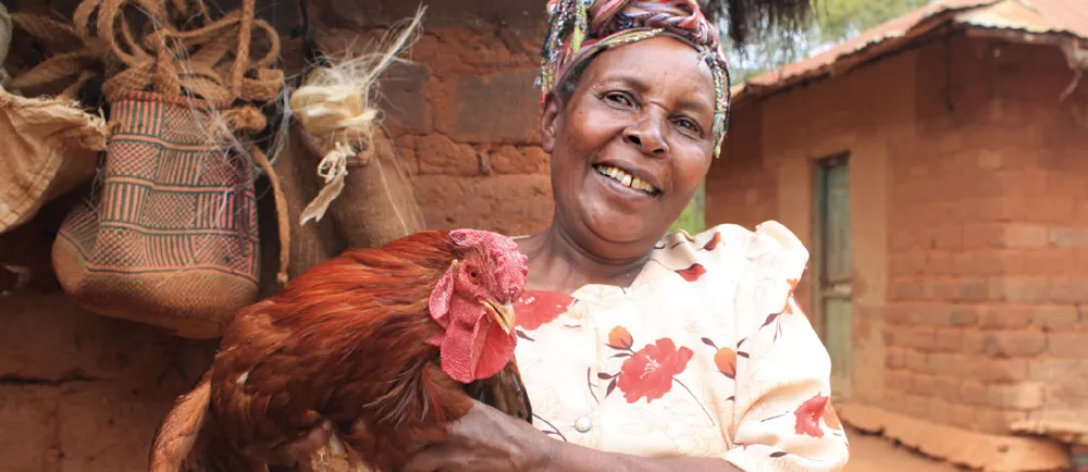 A woman holding a chicken