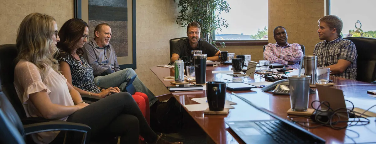 People in a boardroom meeting around a table