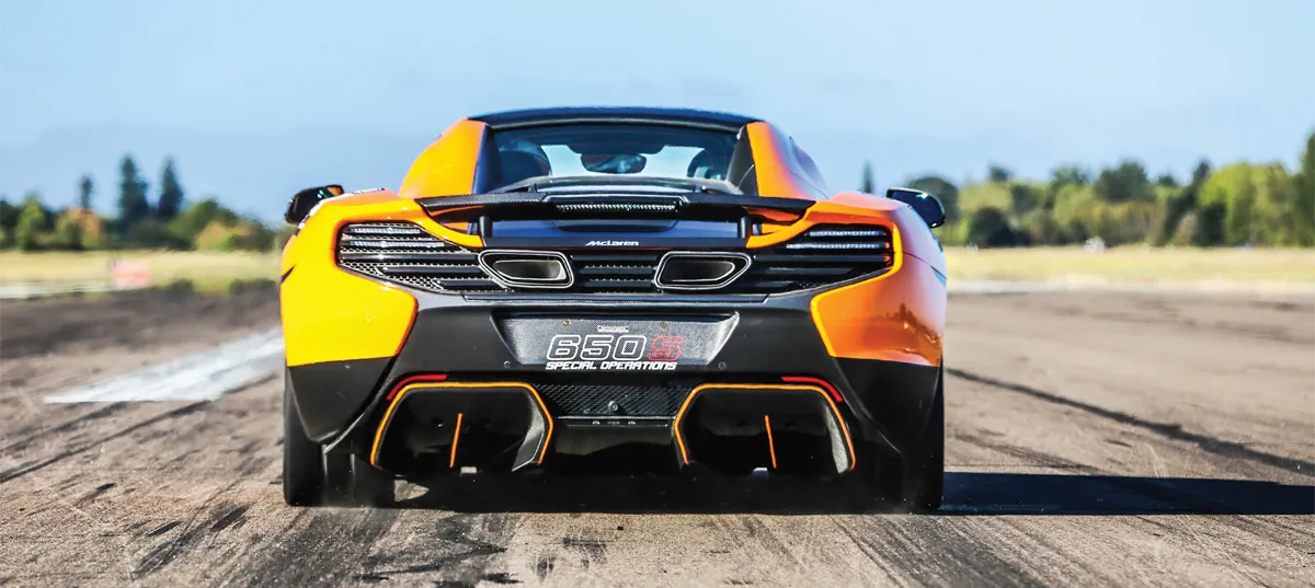 An orange and black race car with number 650