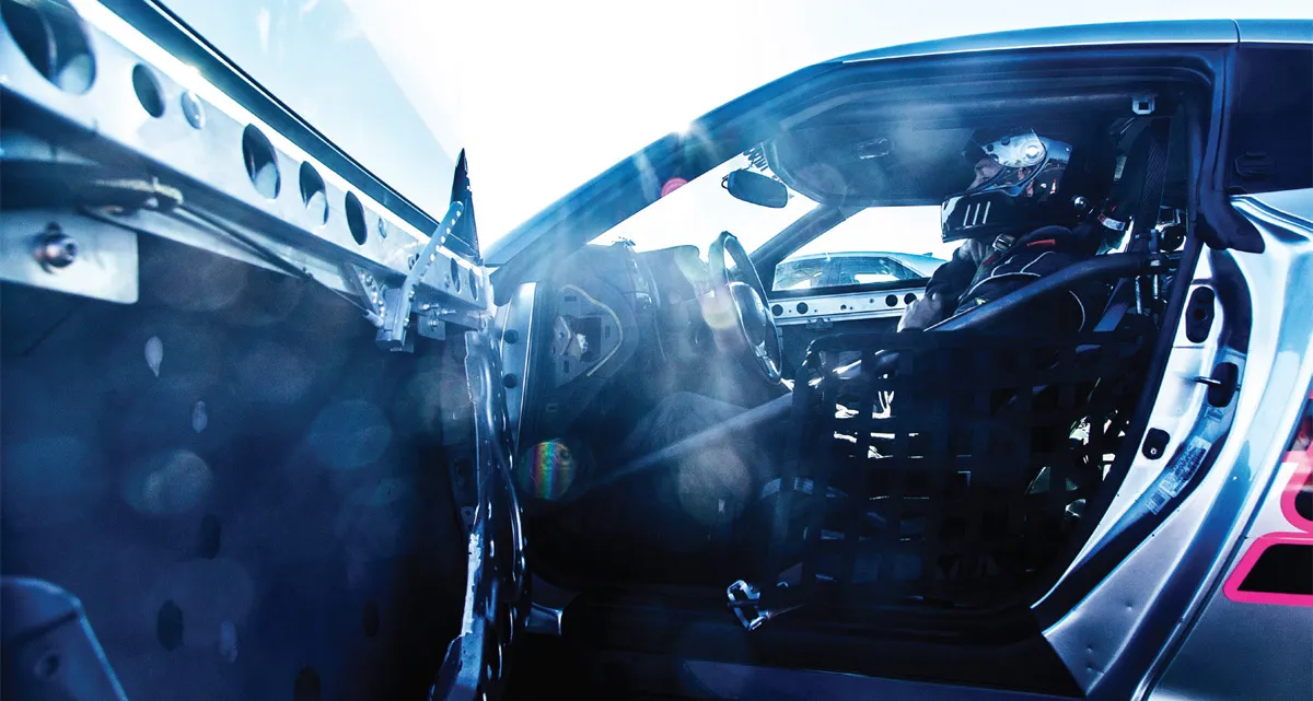 Racing car cockpit with driver in helmet