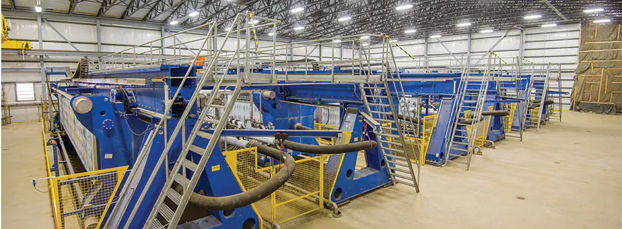 Blue industrial machinery line in a factory