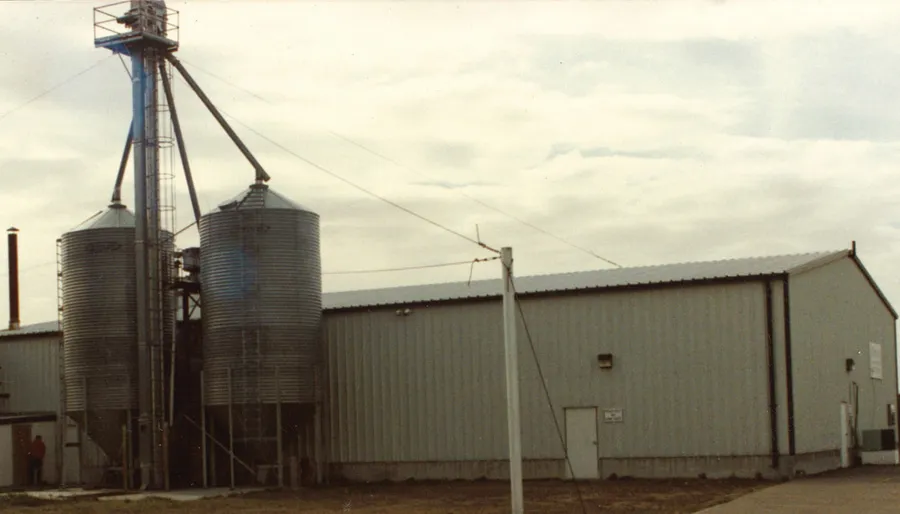 Grain silos beside metal warehouse