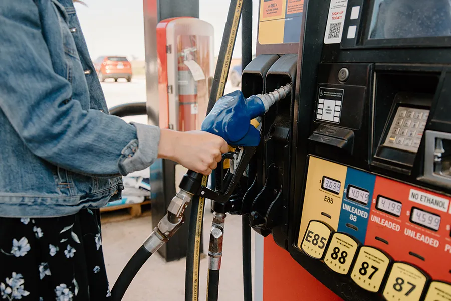 Person refueling at a gas pump