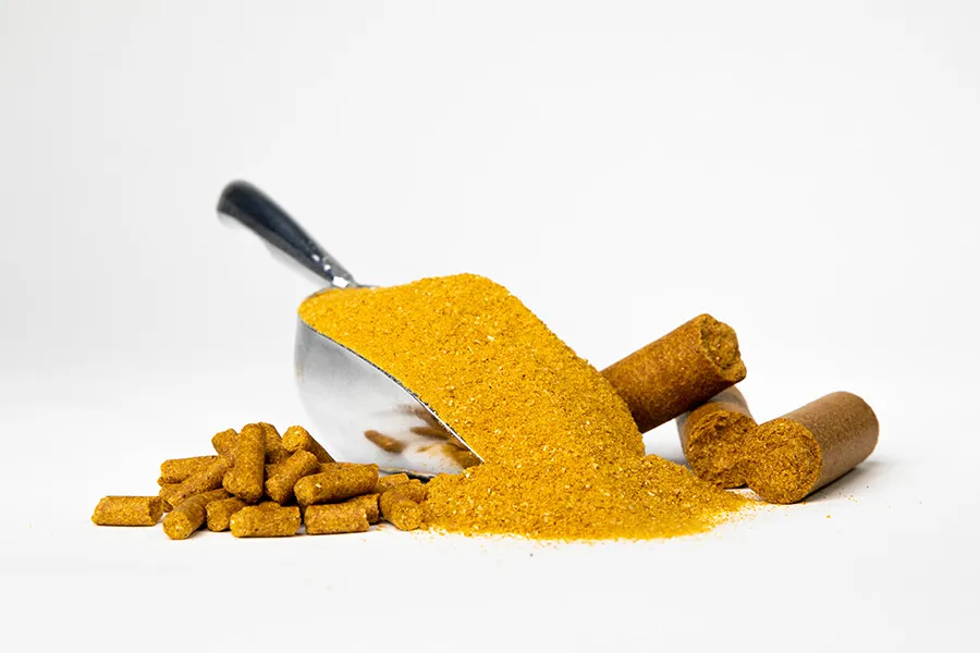 Scoop with yellow powder and pellets