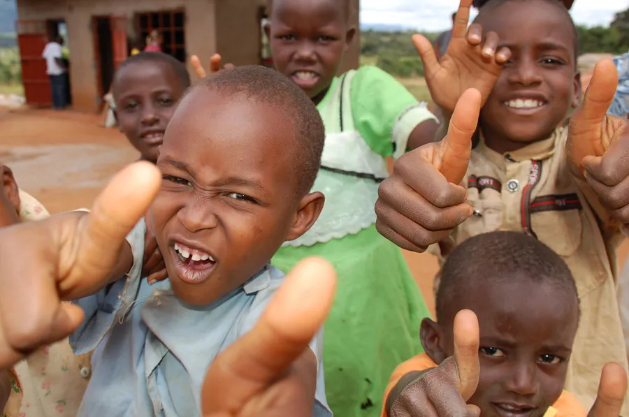 Kids give thumbs-up to the camera