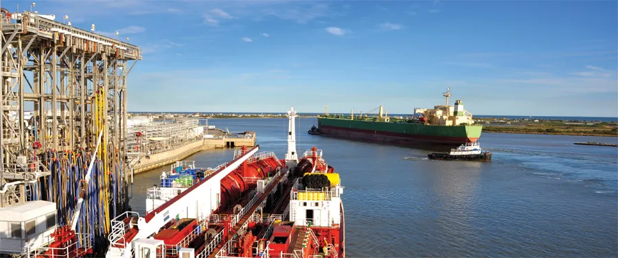 Harbor scene with cargo ship and tugboats