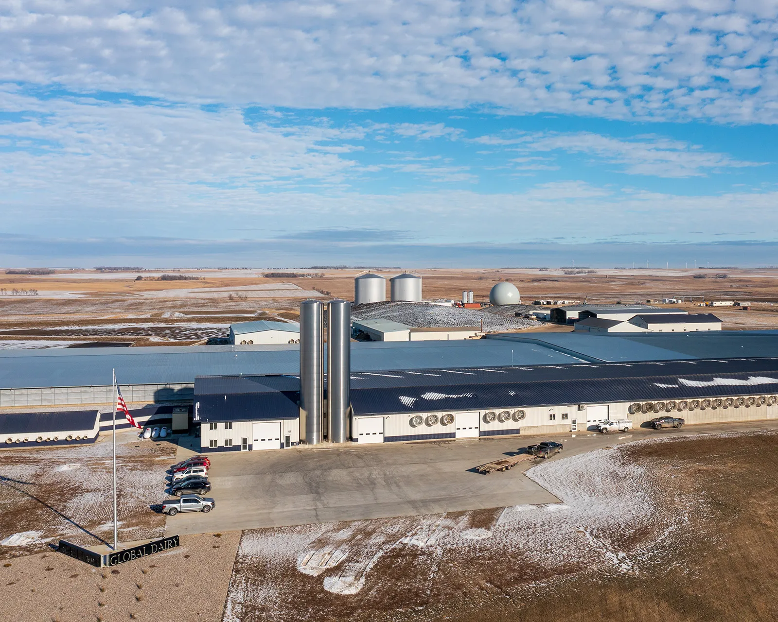 Global Dairy plant with tall silos in field