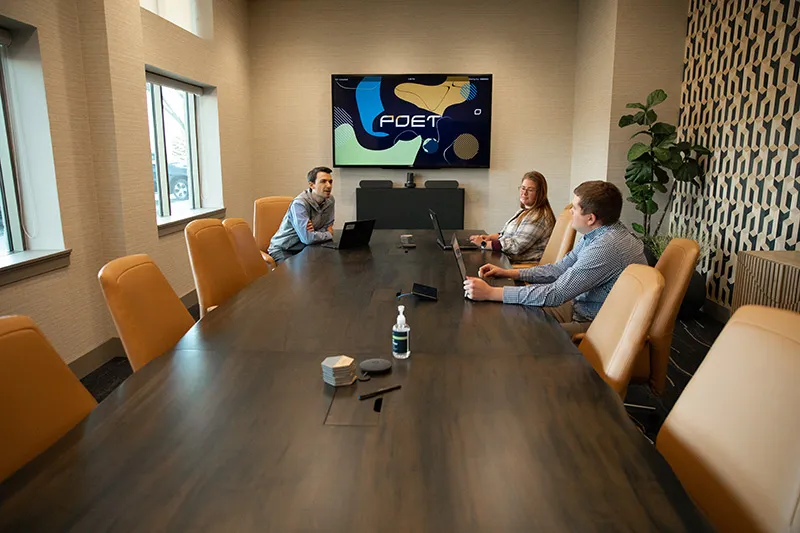Colleagues gather for a meeting around a table
