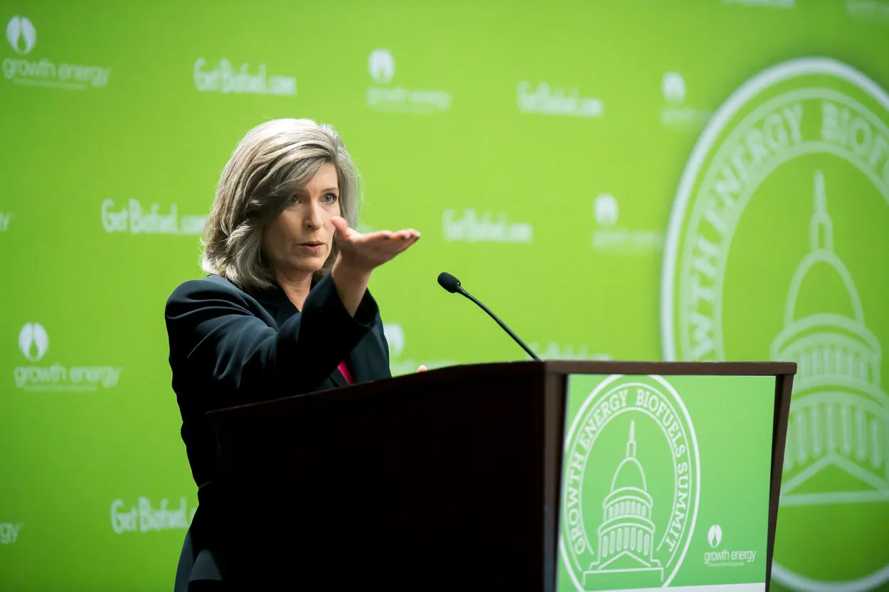 Sen. Joni Ernst speaking at podium at green-energy summit