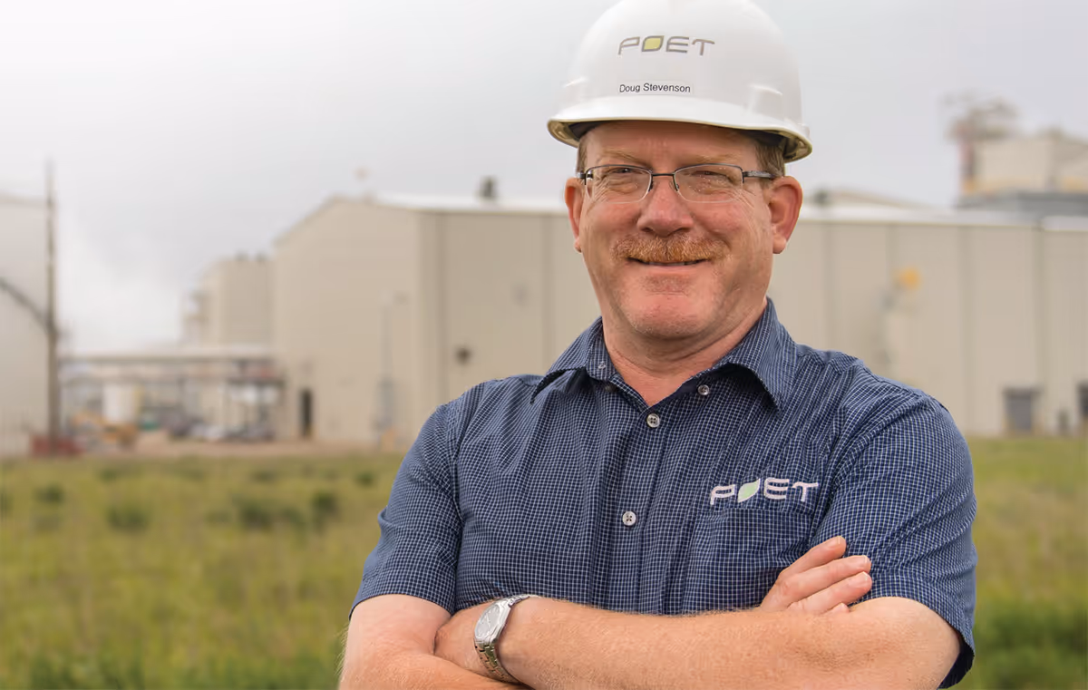Man in POET helmet outside industrial site