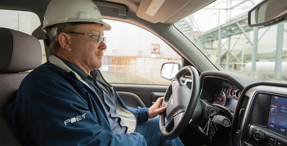 Man in POET helmet inside a car