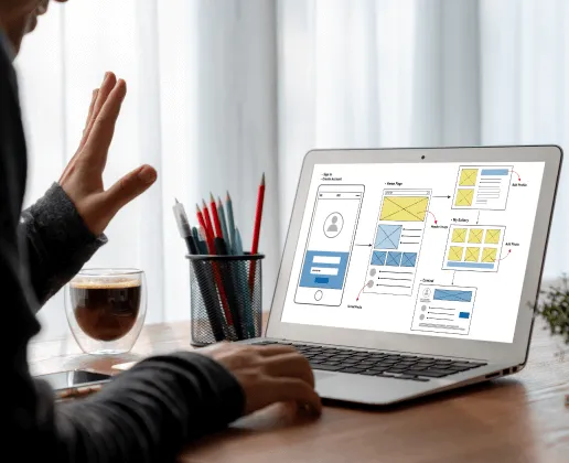 A person sitting at a table with a laptop.