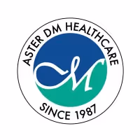Logo of Aster DM Healthcare with stylized initials 'aM' in blue and green circle, surrounded by text 'Aster DM Healthcare Since 1987'.
