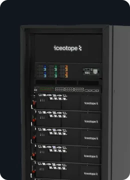 Black server rack with multiple Iceotope branded units and network equipment inside a dark room.
