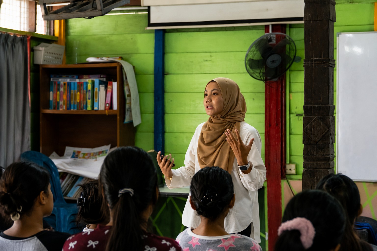Healthcare volunteer conducting a health awareness talk for community members during the LaunchPad programme.