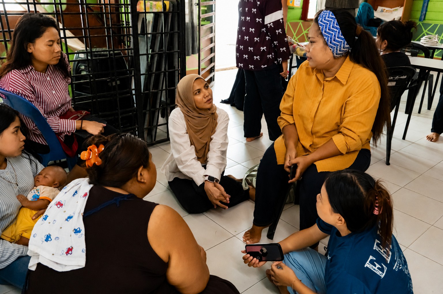 Healthcare volunteers interacting with community members through a small group health awareness discussion.