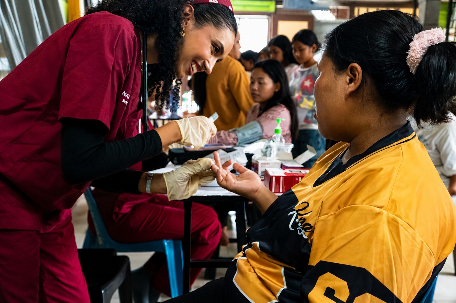 Healthcare volunteer performing a basic health screening for a community participant during the outreach programme.