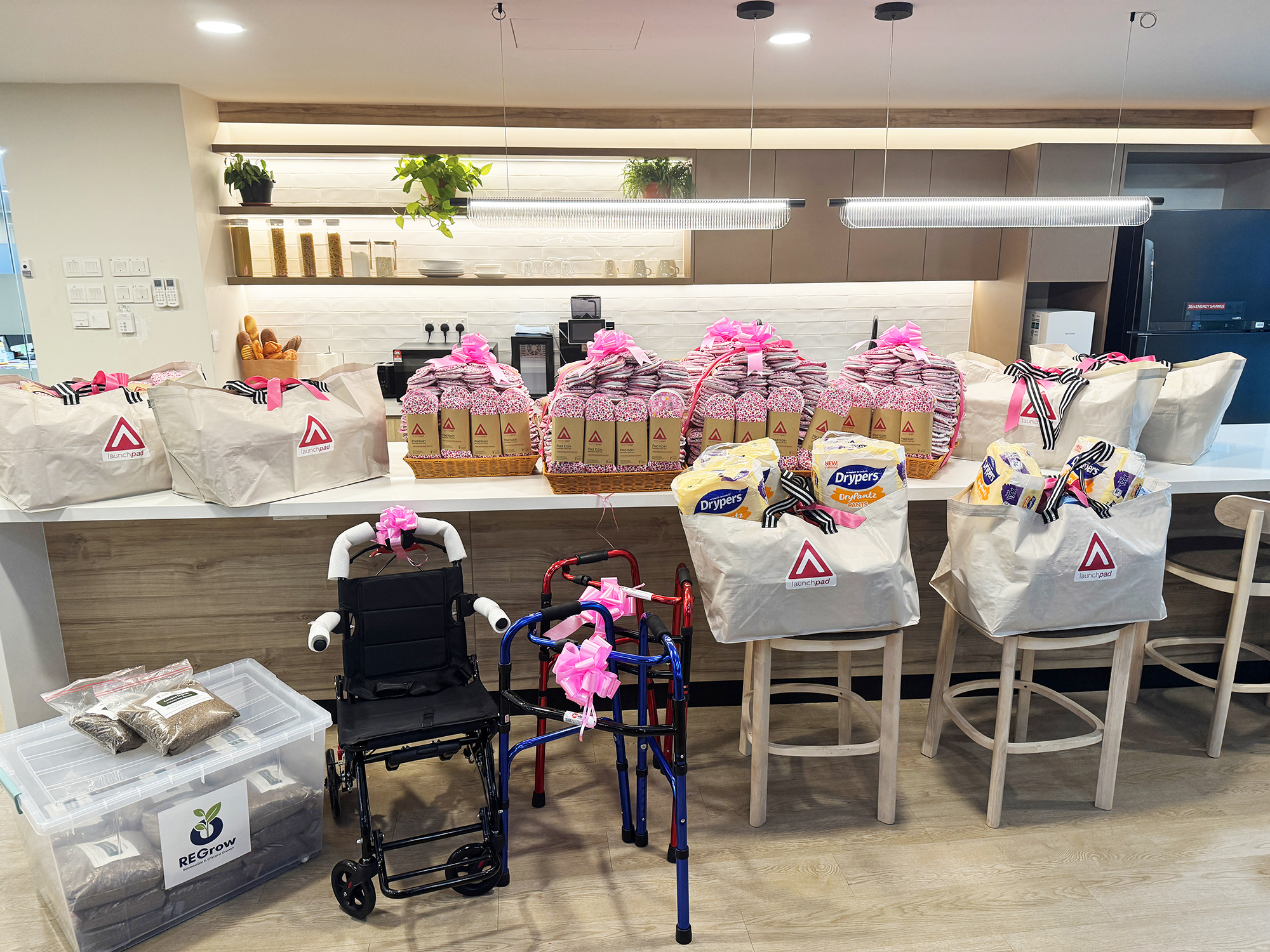 LaunchPad care packages containing reusable cloth pads, essential supplies, and mobility aids prepared for the Orang Asli community.