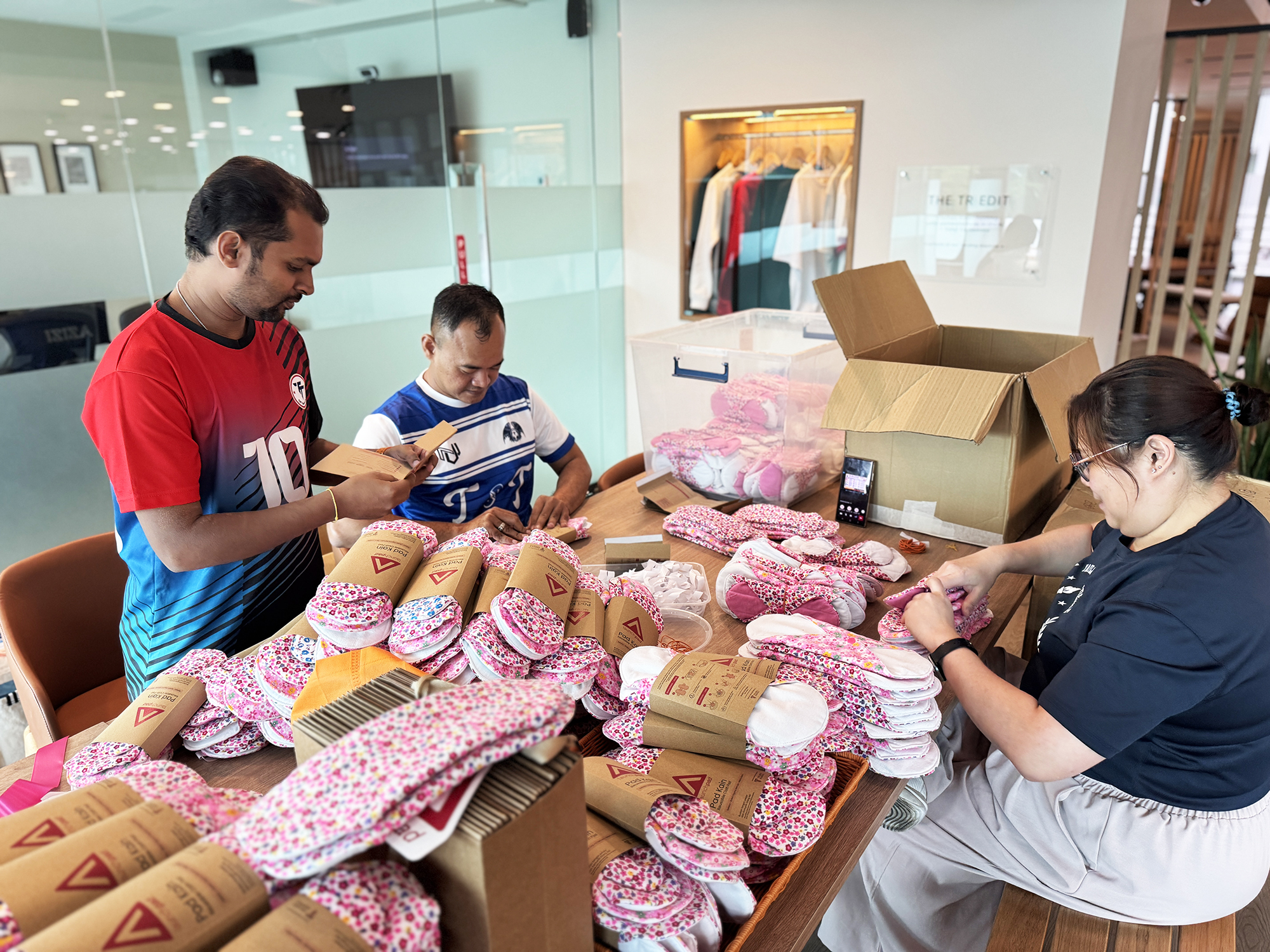 Volunteers packaging reusable cloth pads and educational materials for the LaunchPad community outreach programme.