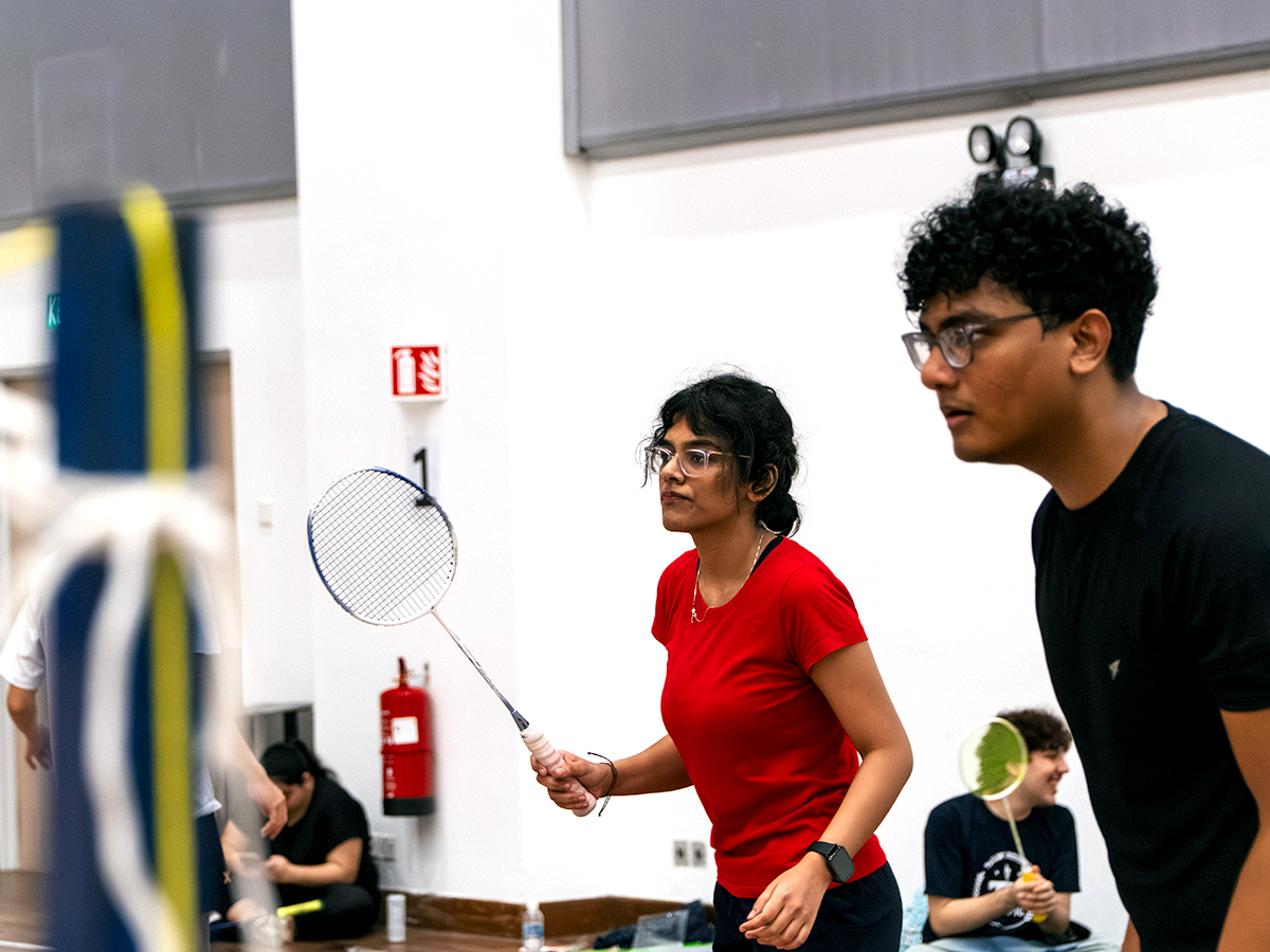Residents competing in a doubles badminton match during the TR Olympics.