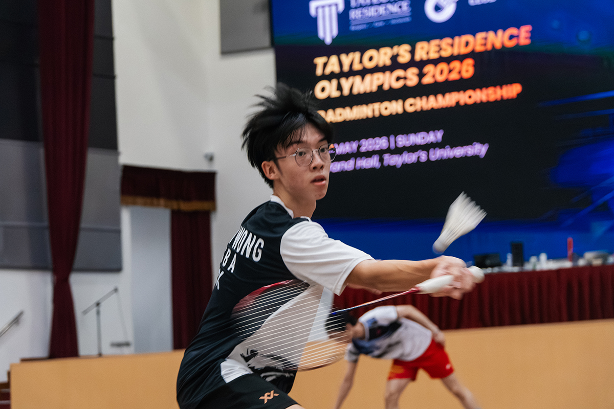 Resident competing in the TR Olympics: Badminton Championship at Taylor’s Lakeside.