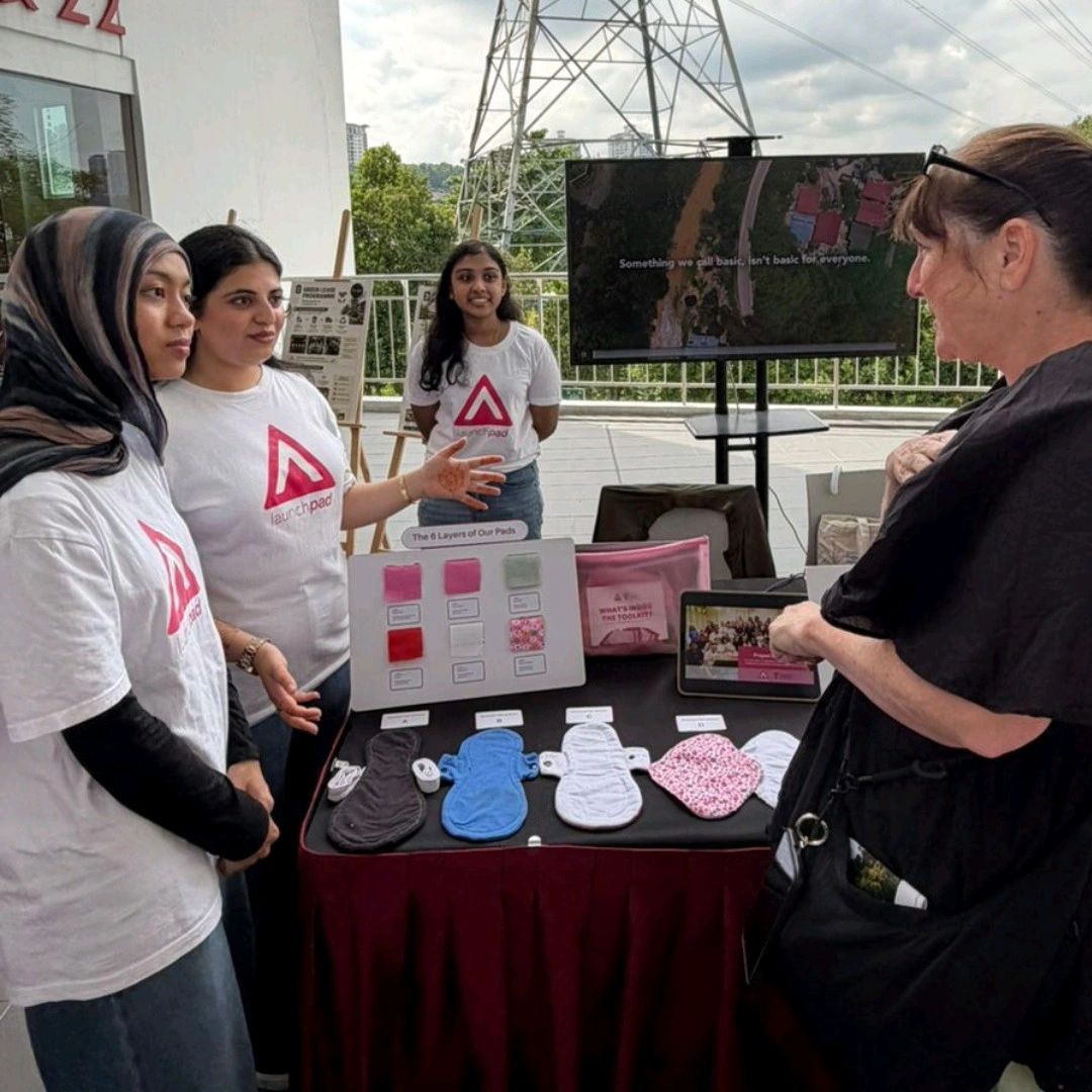 Student volunteers introducing the LaunchPad initiative and reusable sanitary pads to a visitor at ESG Festival 6.0.