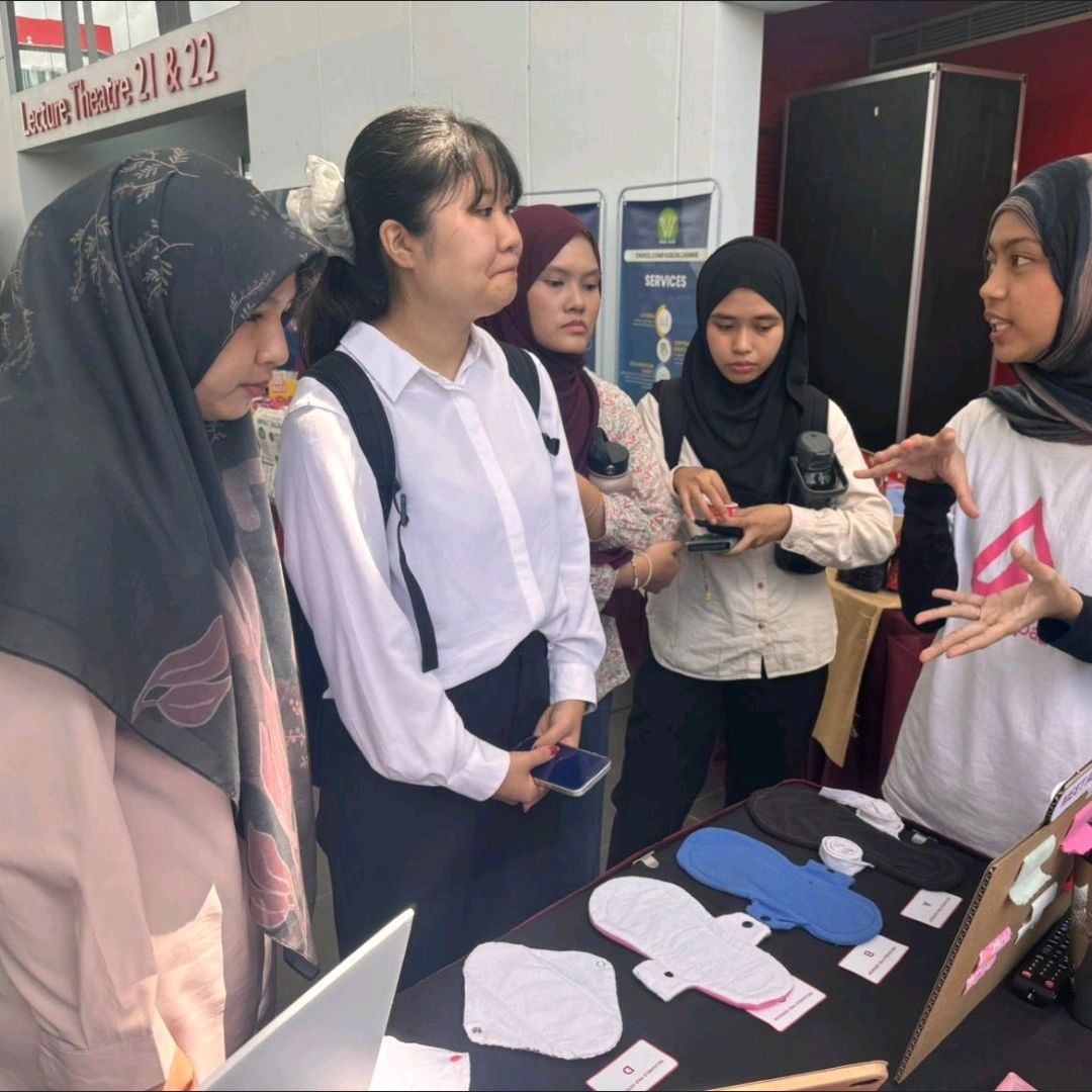 Student volunteers explaining LaunchPad and its reusable sanitary pad initiative to festival visitors.