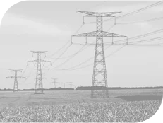 Series of electrical transmission towers spanning across a flat landscape with grass in the foreground.