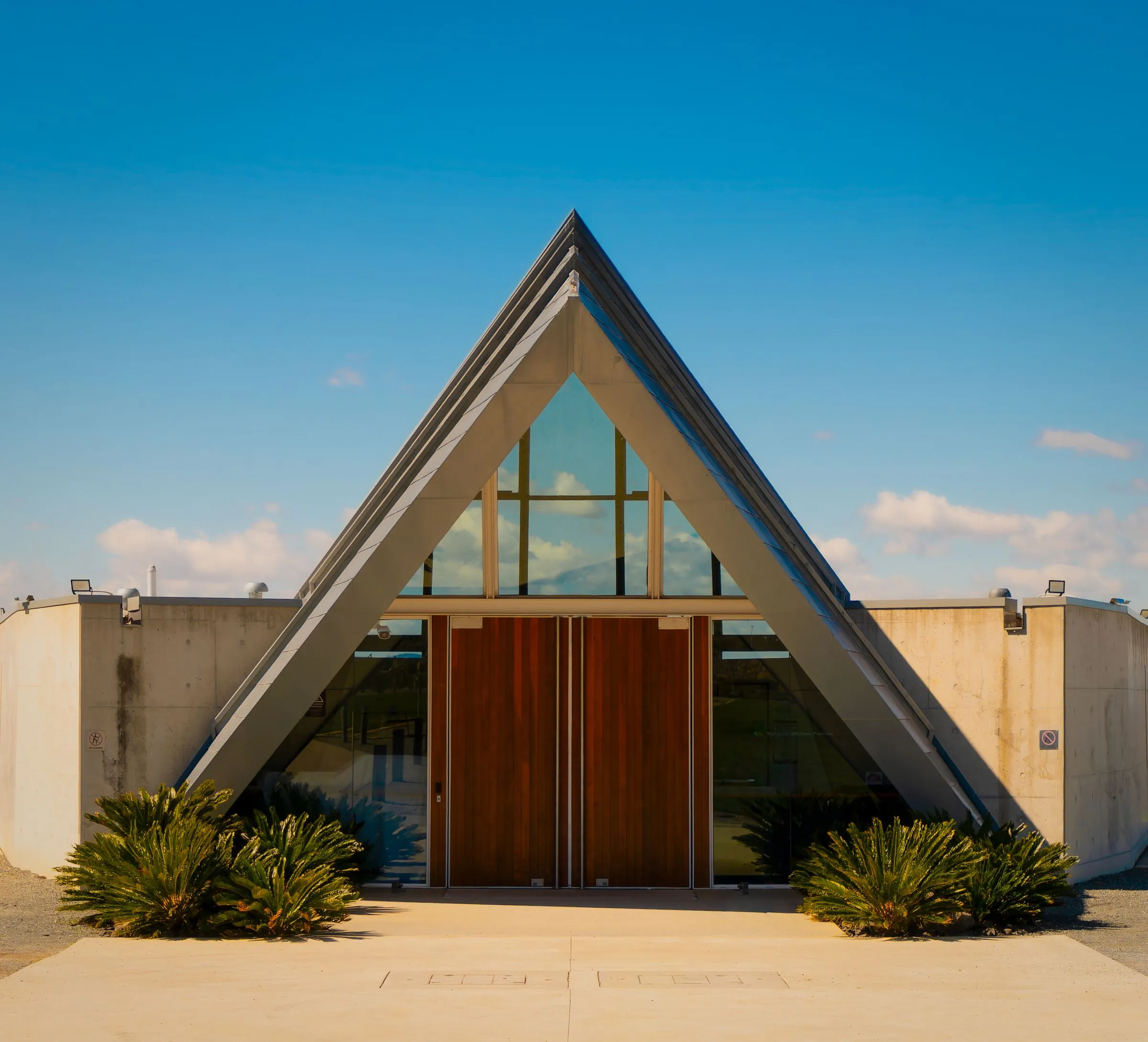 A modern chapel with a glass and timber front