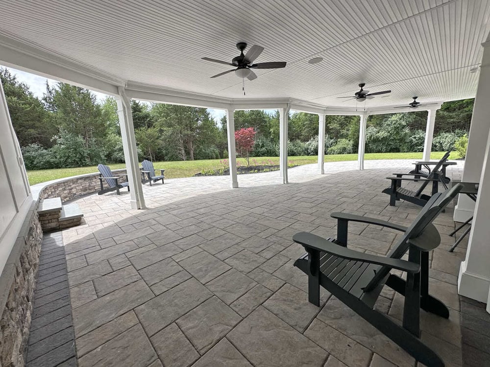 Under deck patio space with integrated gutter system by Deckscapes of Virginia