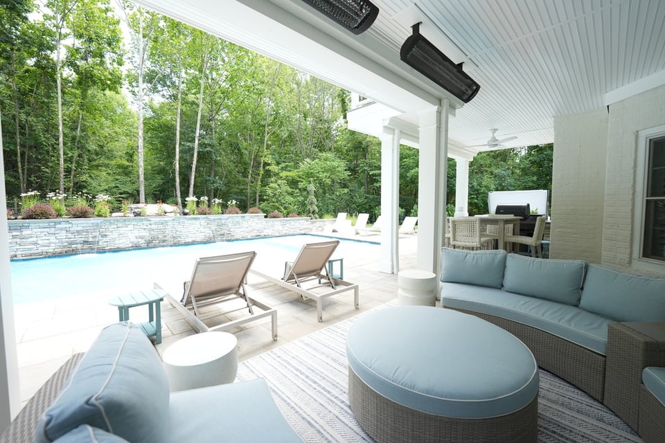 Covered patio in northern va with seating next to pool