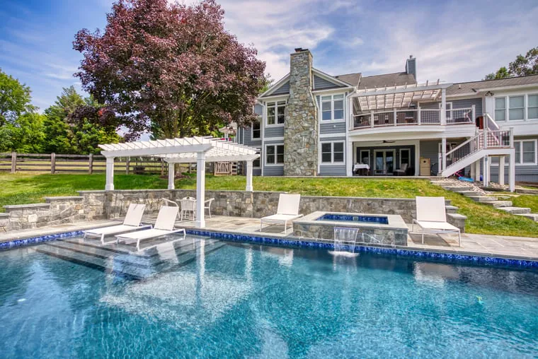Struxure pergola on side of in-ground pool with tanning ledge in Northern VA