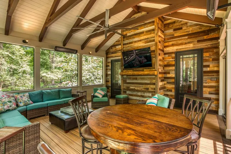 screened porch with furniture dining table ceiling fans floating tv and heaters