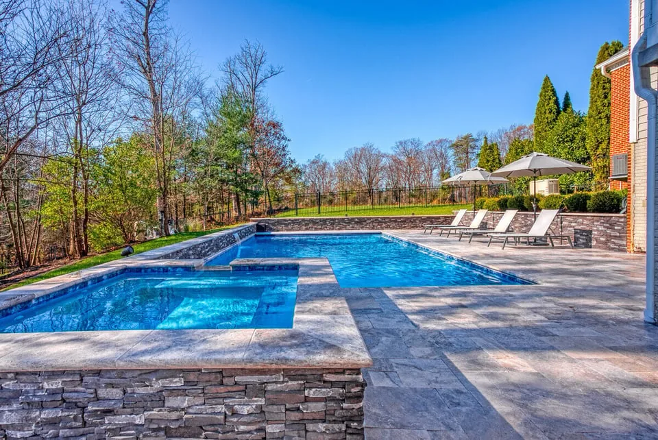 Hot tub and gunite pool by Deckscapes of VA