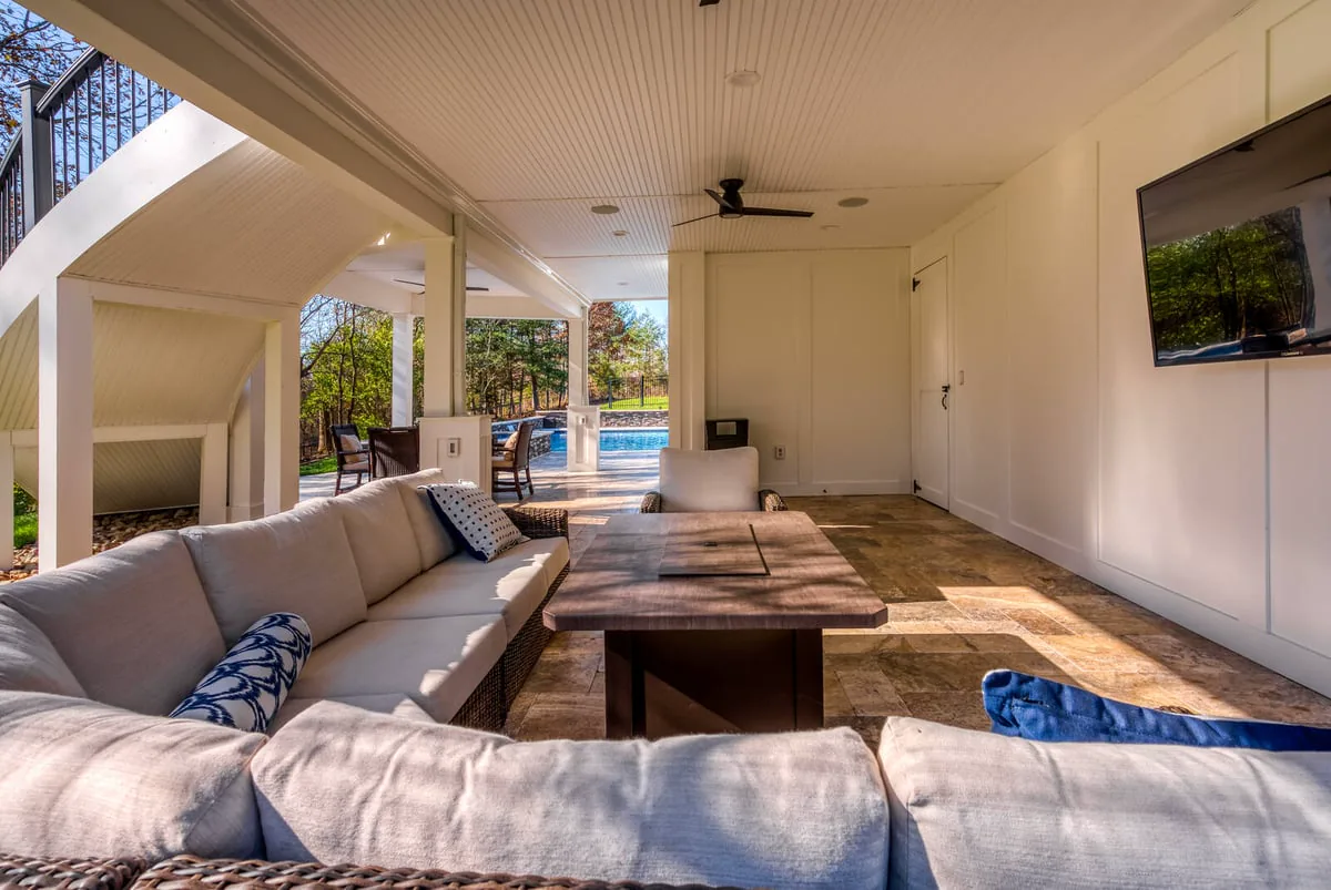 white-under-patio-system-with-patio-furniture-and-floating-tv-and-fans-in-northern-virginia 