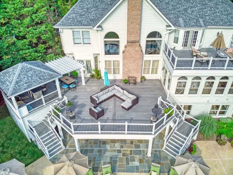 Aerial view of raised deck and attached porch with outdoor kitchen