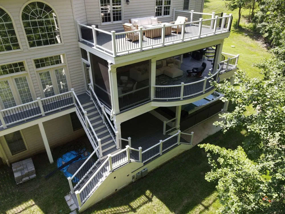 Drone view of multi-level deck with covered ground level by Deckscapes of Virginia