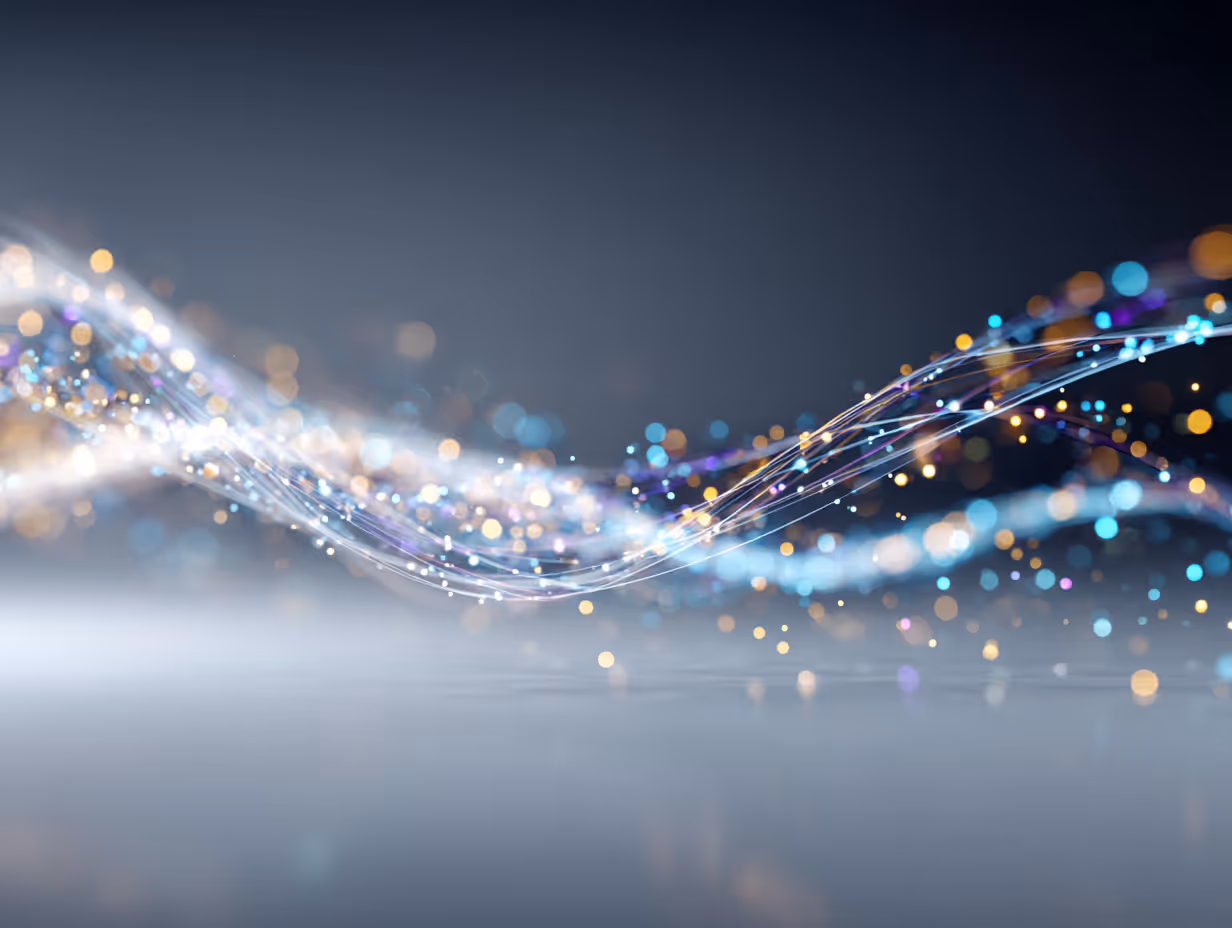 Abstract flowing wave of glowing particles and light trails in blue, orange, and purple on a dark gradient background.