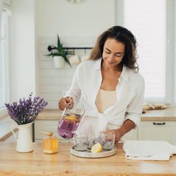 Lavender Key Lime Martini recipe with ingredients and preparation steps on a lavender background with lavender flower illustrations at the bottom.