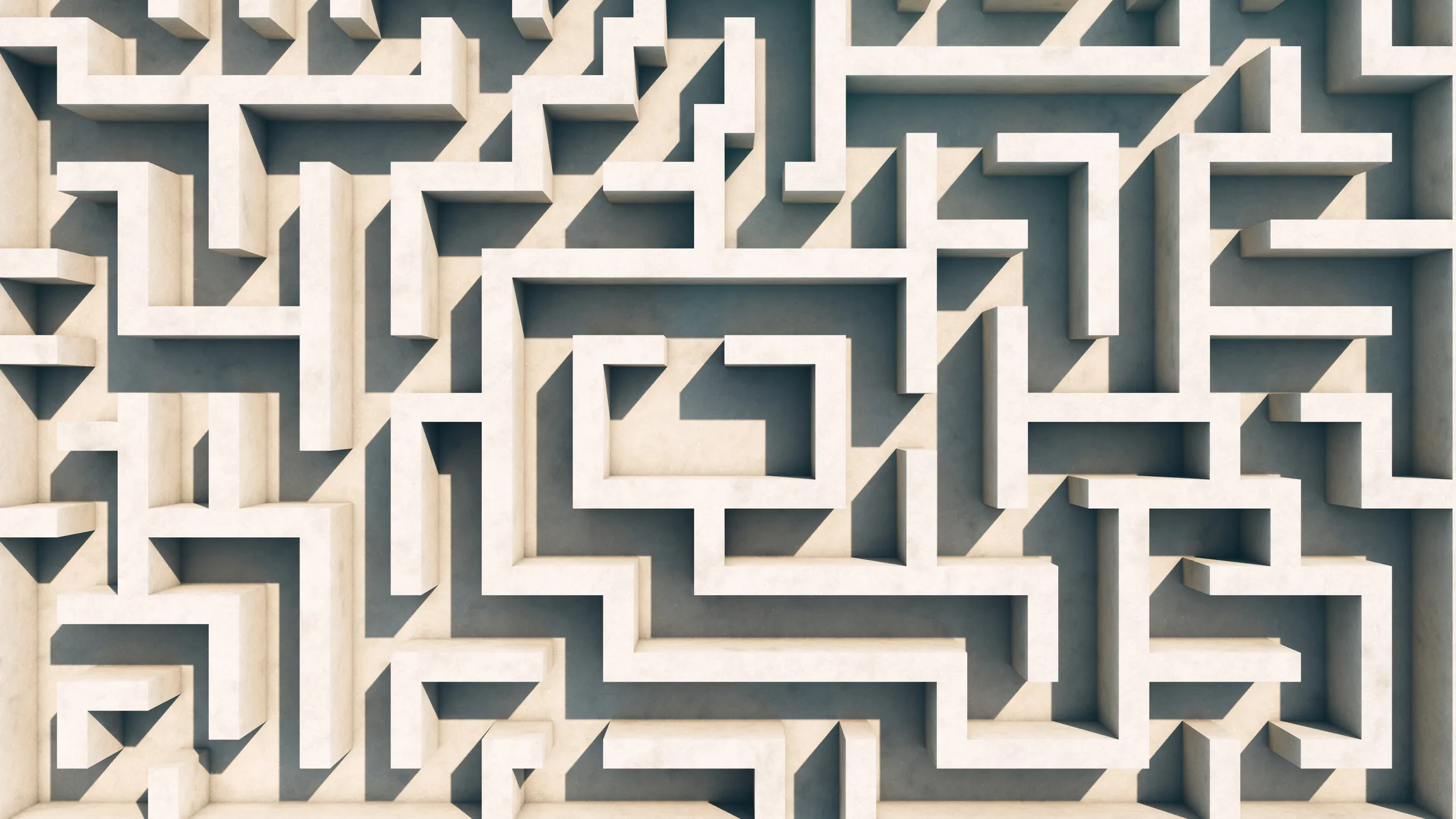 Top-down view of a beige three-dimensional maze with multiple twists and turns.