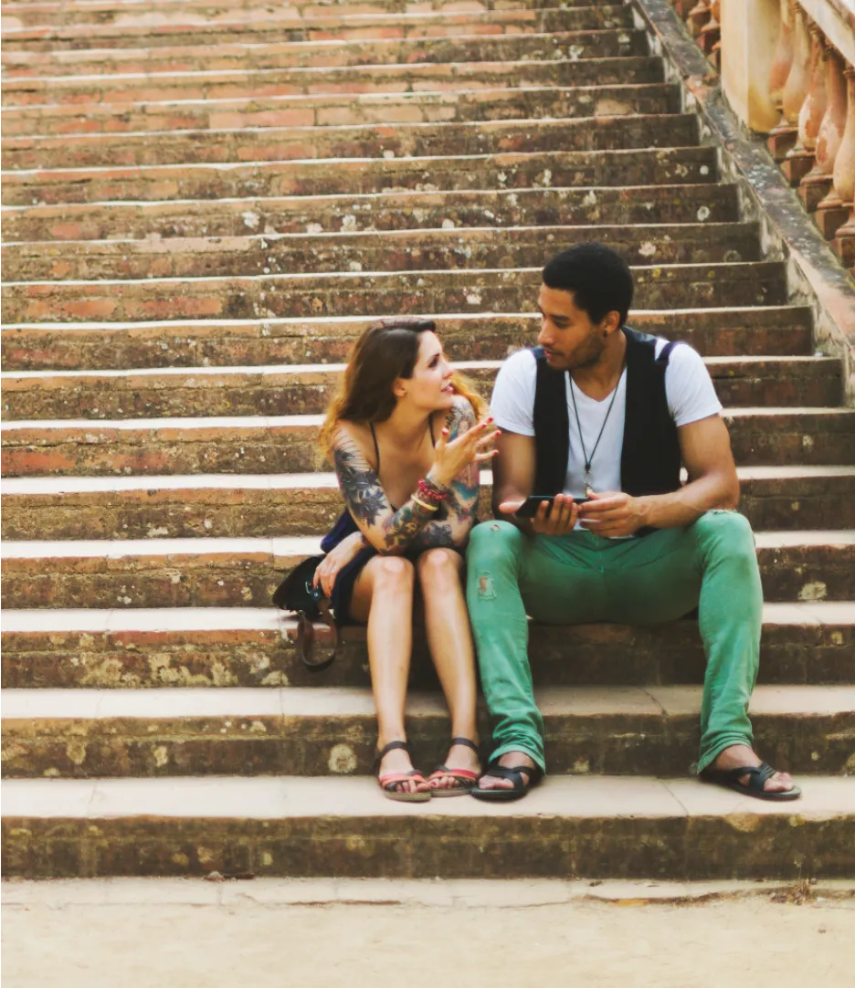 Man wearing a mustard beanie and apron working behind a counter in a cozy indoor setting.